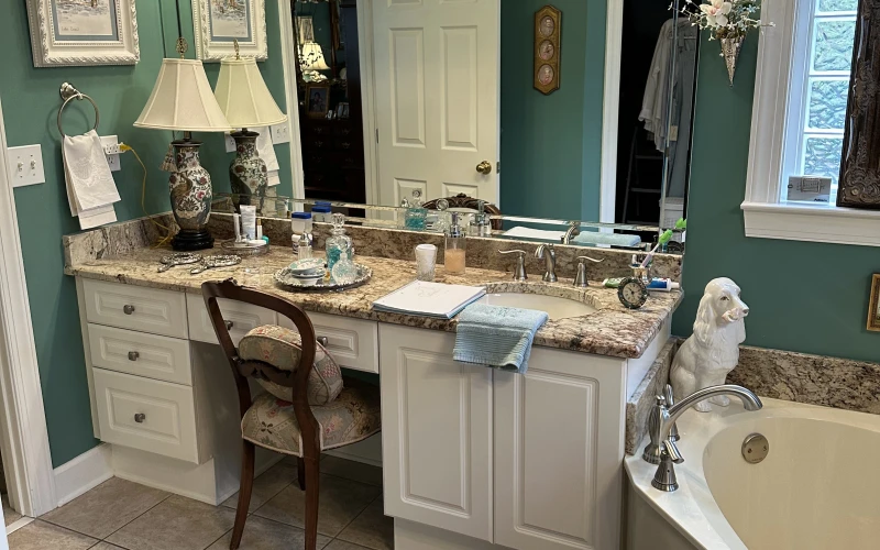 Newly installed white shaker-style kitchen cabinets with open shelving in a Mountainbrook home remodeled by The Old Town Remodeler Inc. The cabinets run floor to ceiling along two walls with aligned doors and brushed hardware.