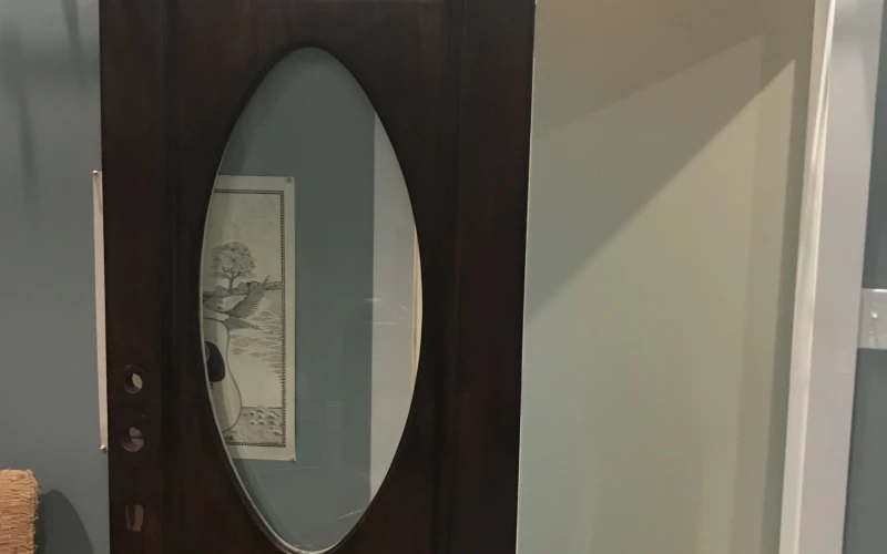 A newly installed front entry door on a traditional single-family home in Mountainbrook, Alabama, with a clean frame fit and visible weatherseal along the threshold. The door sits flush in the opening with no visible gaps between the door edge and the frame.